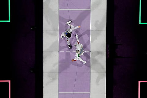 Fencers compete during men's team foil final match